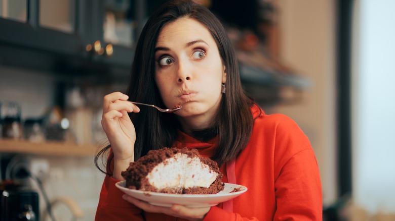 woman splurging on cake