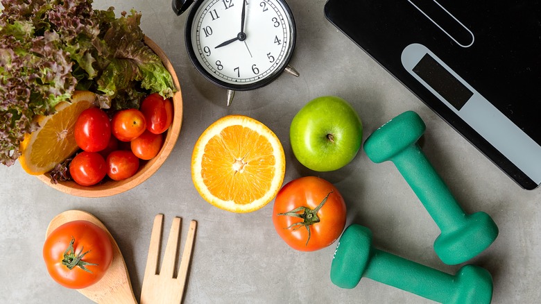 healthy foods, dumbbell, and alarm clock