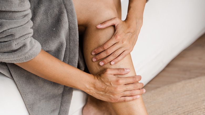 Pair of hands massaging their leg