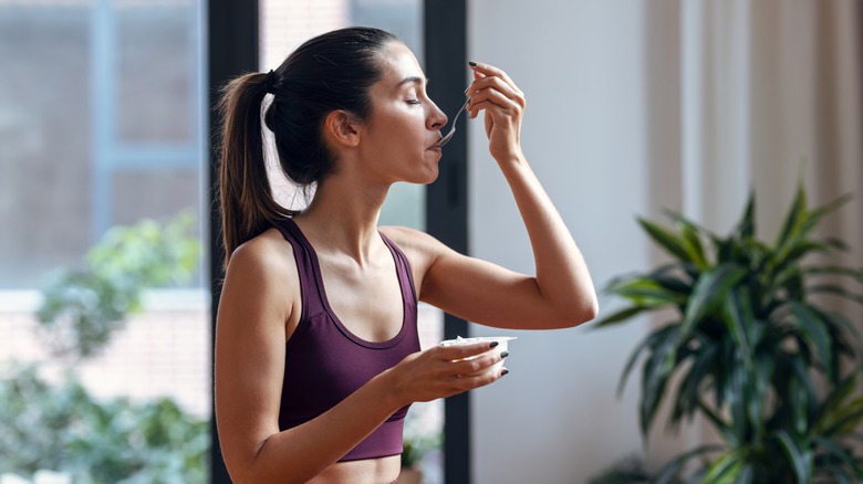 woman in fitness clothing eating