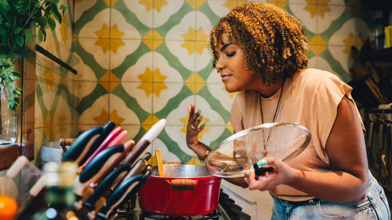 Woman cooking on stove