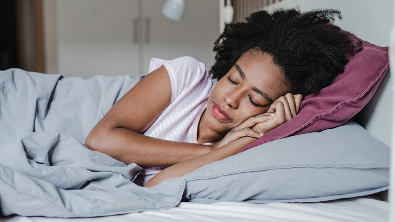 Woman sleeping in on weekend 