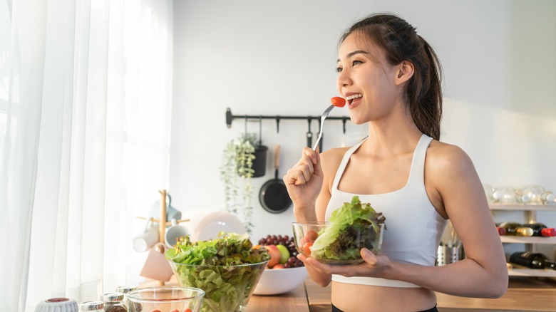 A woman eats a salad