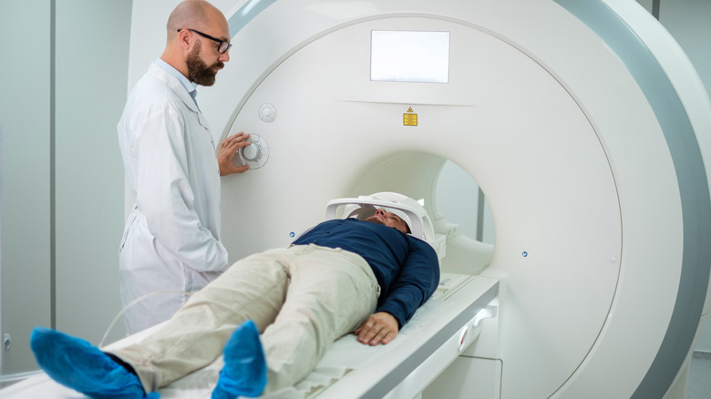 Technician assisting CT scan