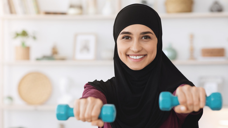 Muslim woman lifting weights
