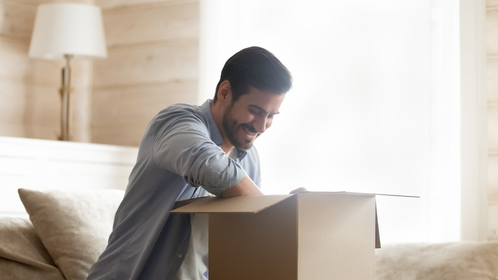 Man unpacking cardboard box