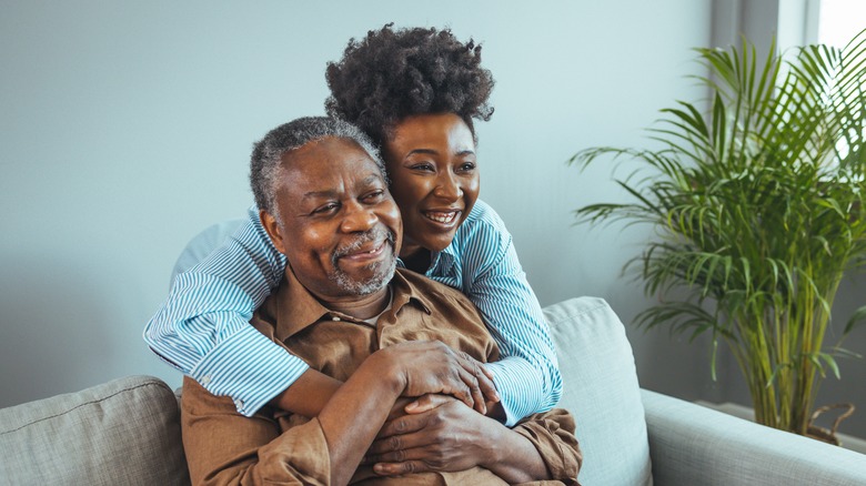 A woman visits her senior father