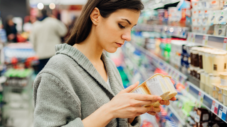 Woman checking date information on food