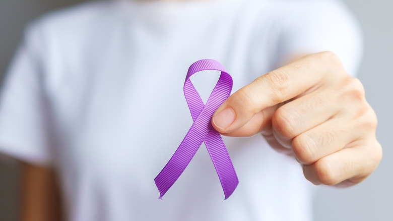 Person with lupus purple awareness ribbon