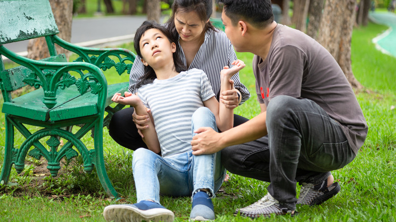 Child suffers from seizure outside in park while parents hold her