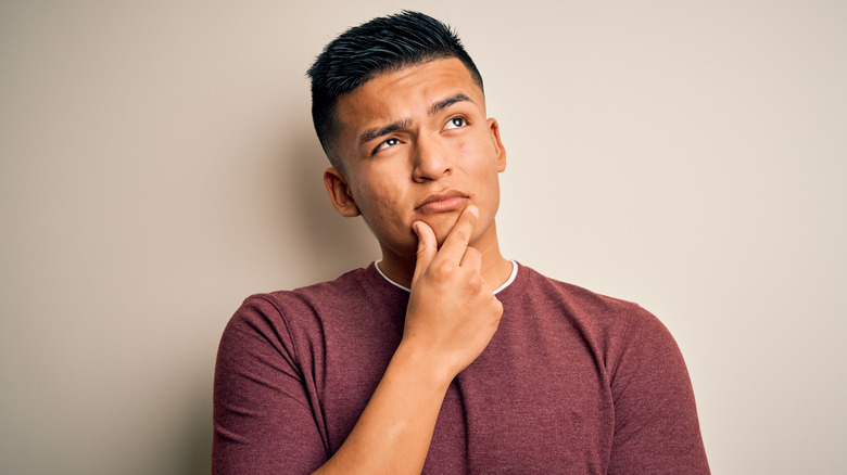 Man thinking with fingers on chin 