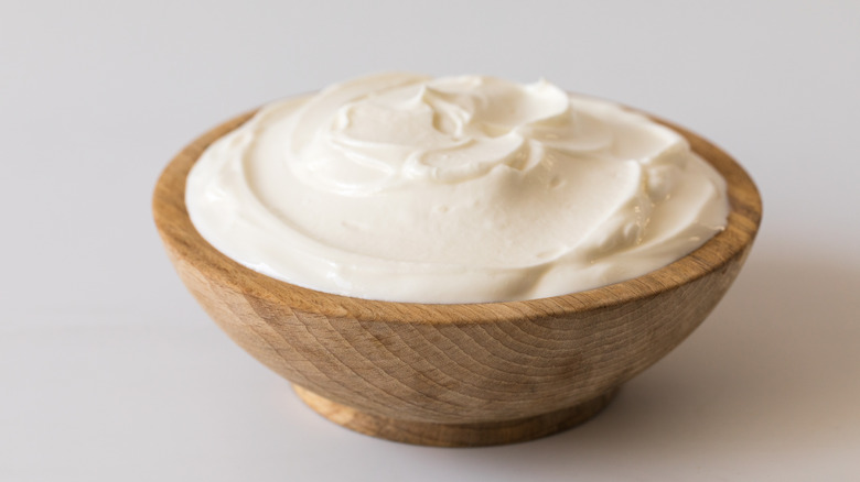 A wooden bowl full of Greek yogurt