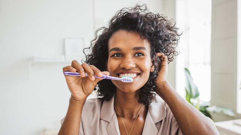 Woman brushing teeth