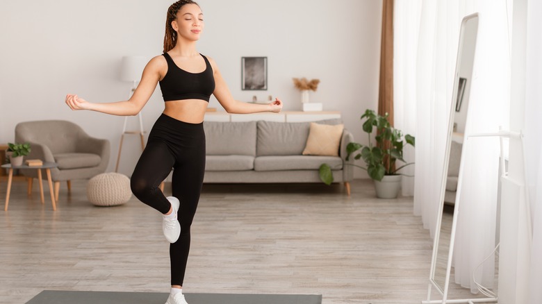 Woman standing on one leg