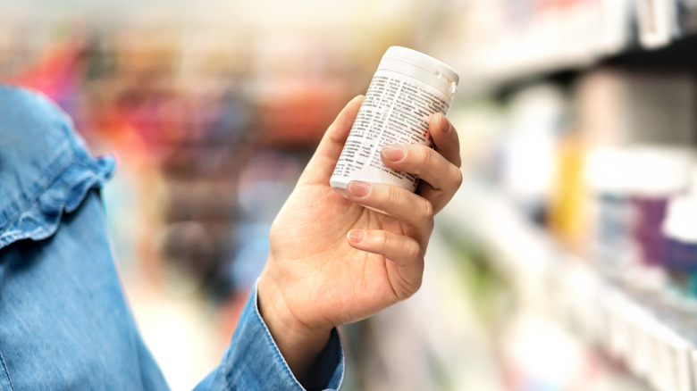 someone holding pill bottle 