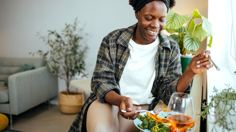 Woman eating grilled vegetables