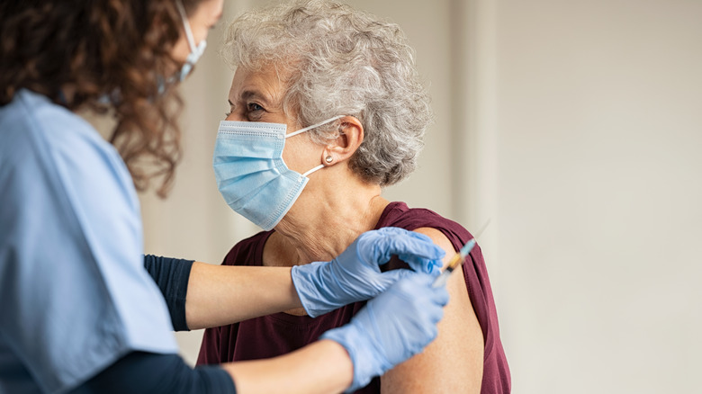 Elderly woman getting vaccinated