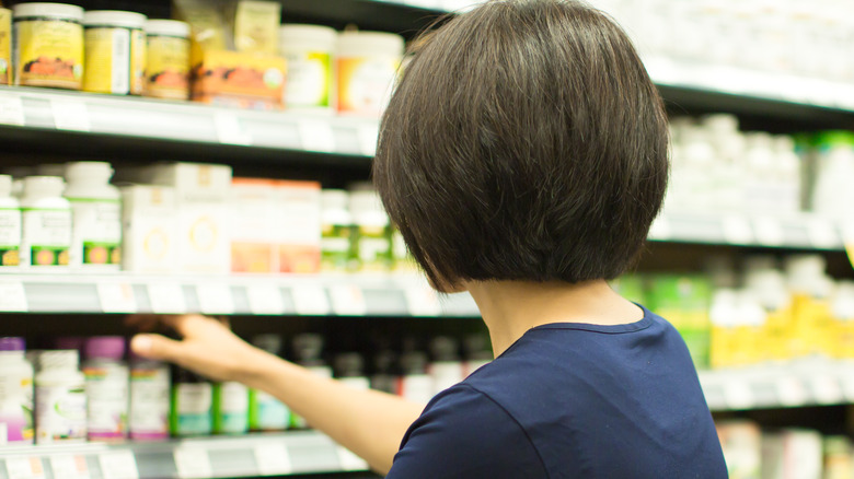 woman choosing supplements