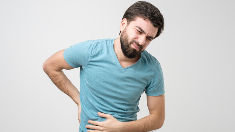 Bearded man showing pain with kidney stones 