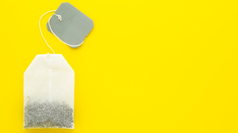 Tea bag on yellow background
