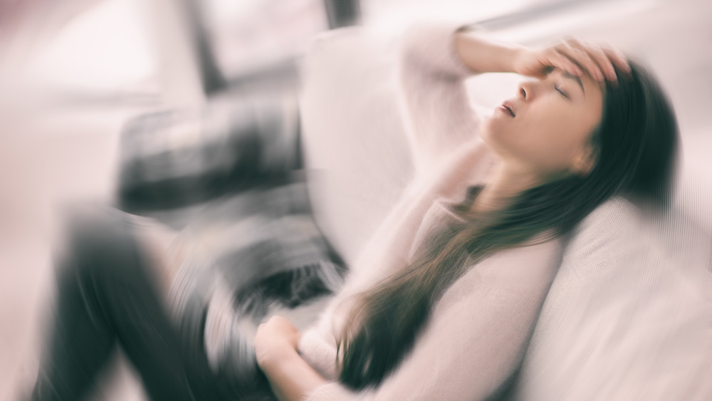 Woman feeling dizzy sick and nauseous