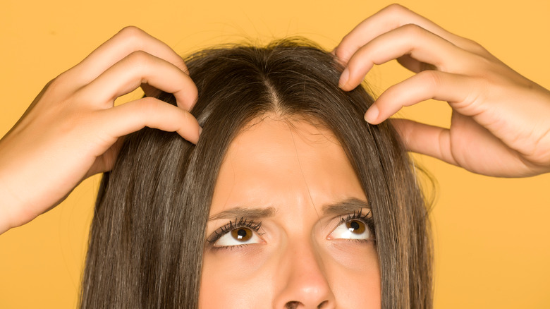 woman scratching her head