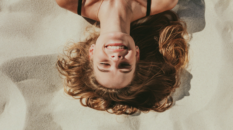 woman lying on sand