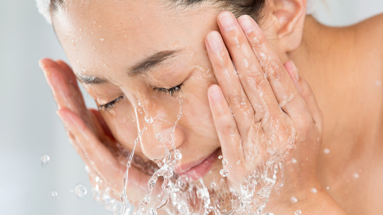 Woman rinsing face