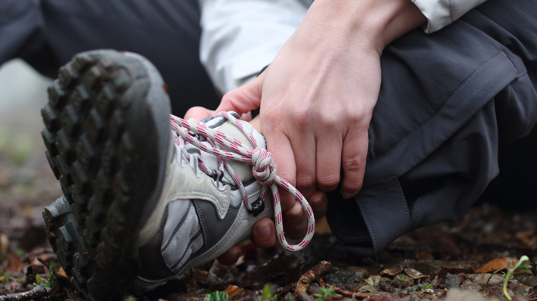 Person holding ankle outside