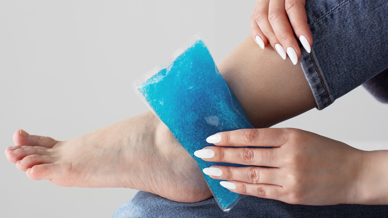 Woman icing her ankle