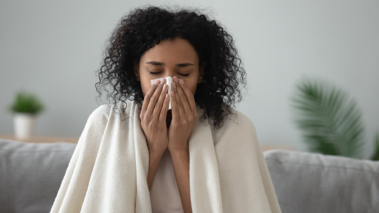 Woman blowing her nose