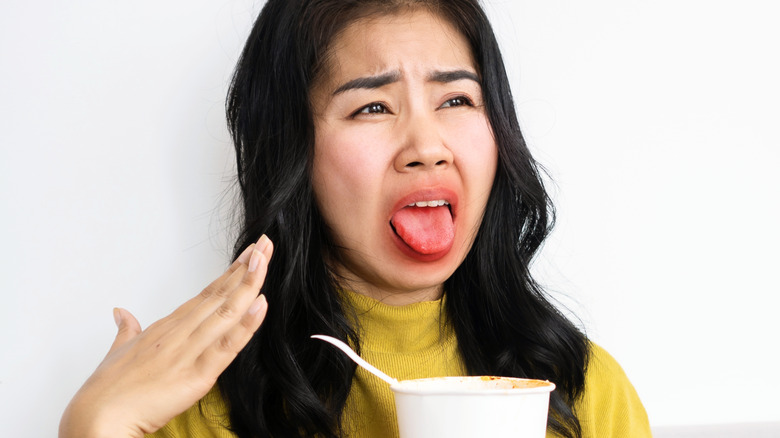 A woman after burning her tongue