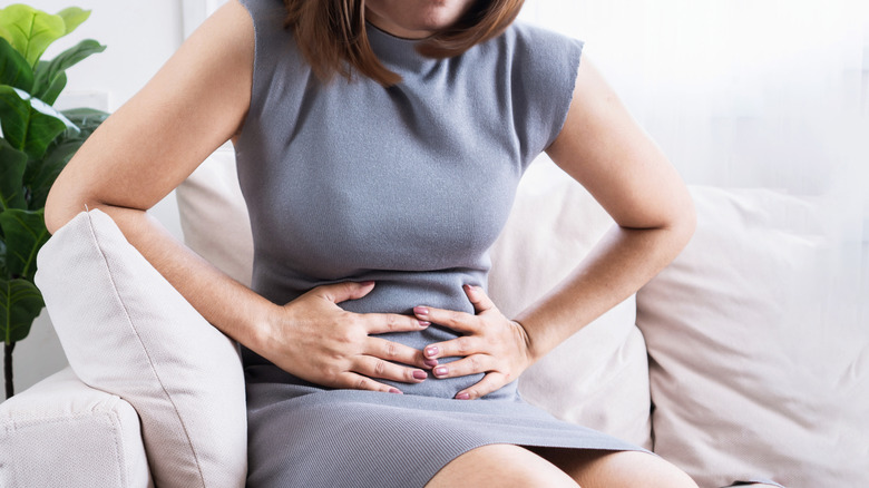 A woman holding her abdomen in pain
