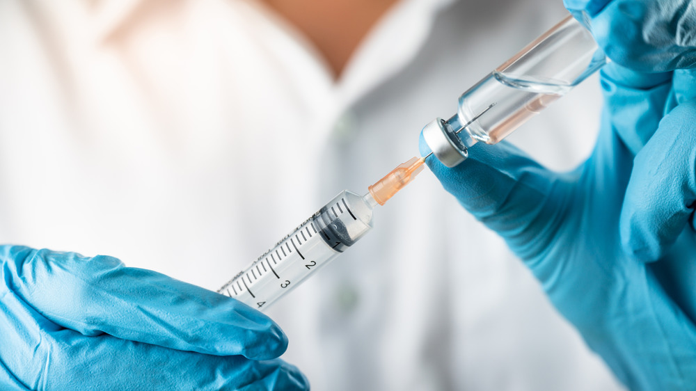 Stock photo of a vaccine and a needle
