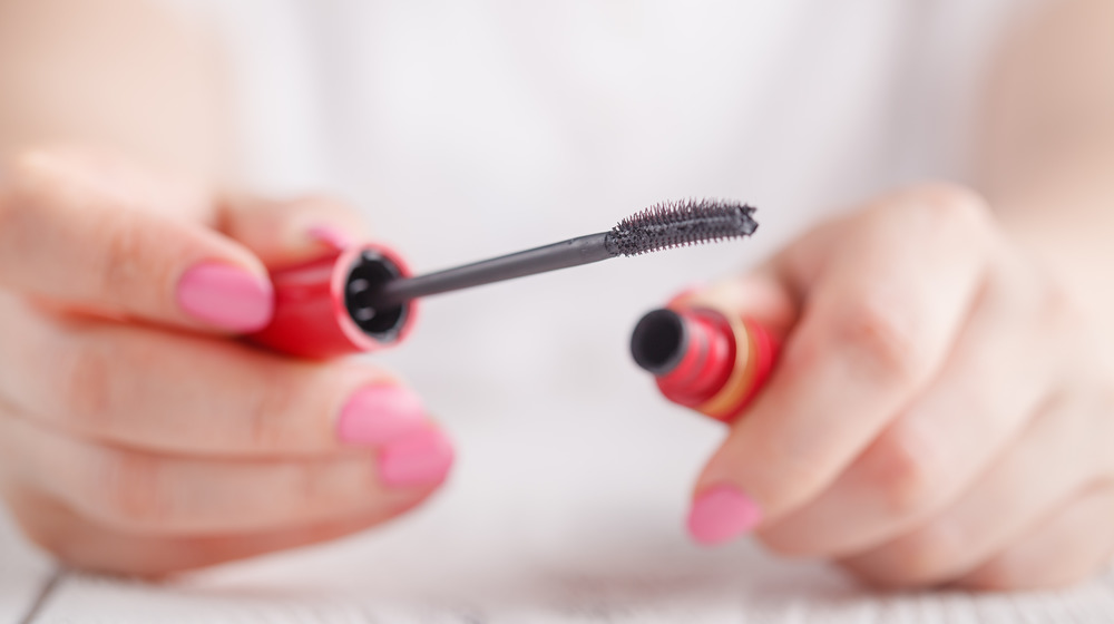 Close up of woman's hands holding mascara