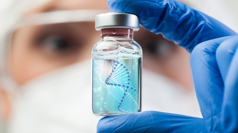 Scientist holding a jar of DNA