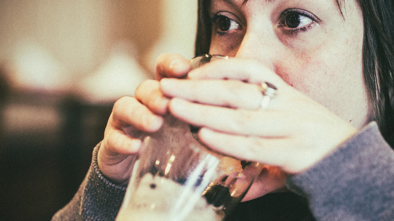 Woman drinking dark beer