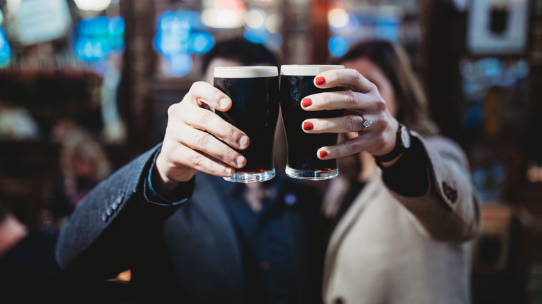 Man and woman drinking Guinness