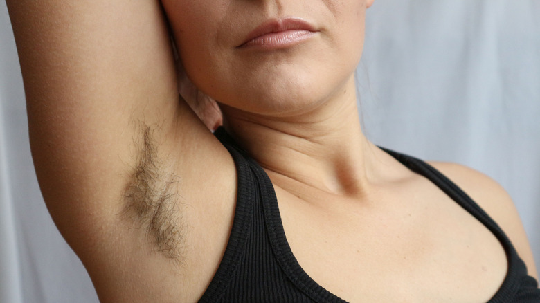 a woman with unshaved armpits