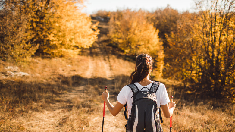 a woman hiking with poles