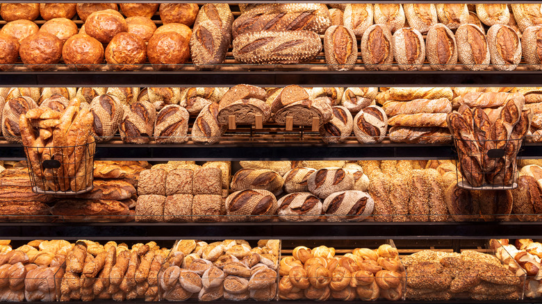 a variety of breads on a shelf