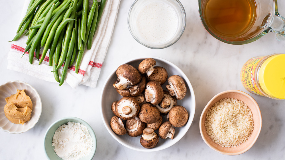 Ingredients gathered on a marble counter to make healthy green bean casserole