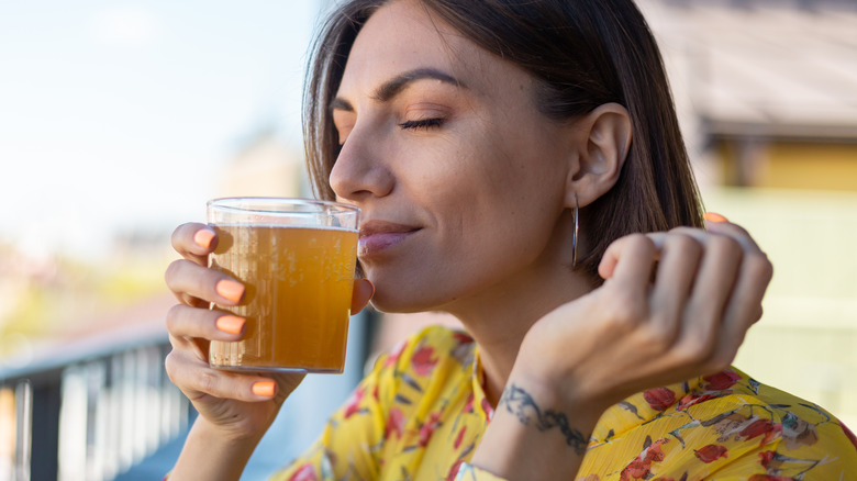 Woman drinking yellow drink