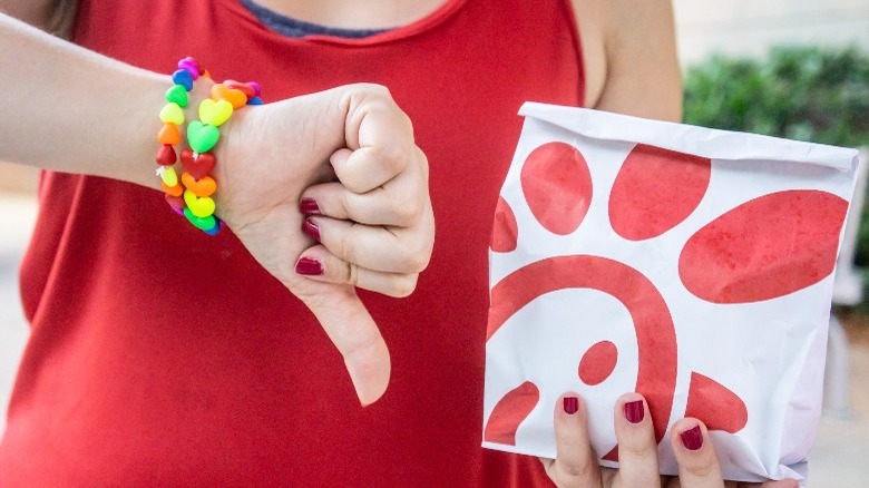 woman gives Chick-fil-A food a thumbs down 