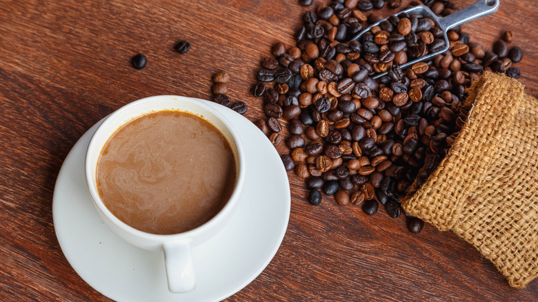 A cup of coffee and coffee beans