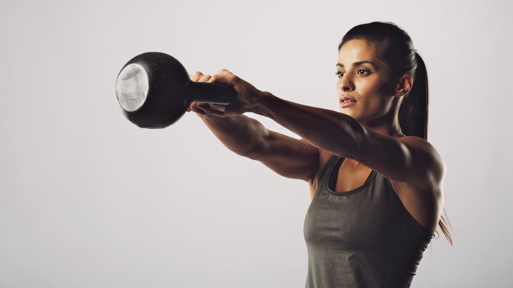 woman doing kettlebell exercise