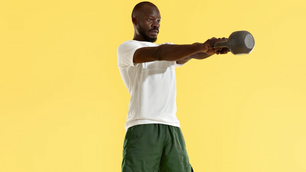 Man doing kettlebell swing exercise