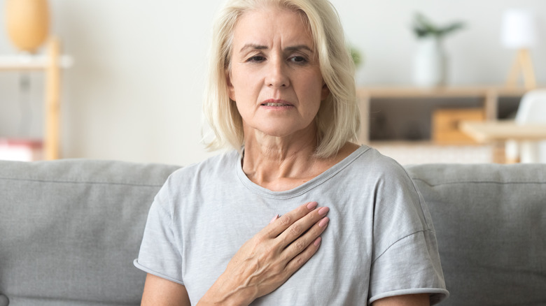 woman holding chest