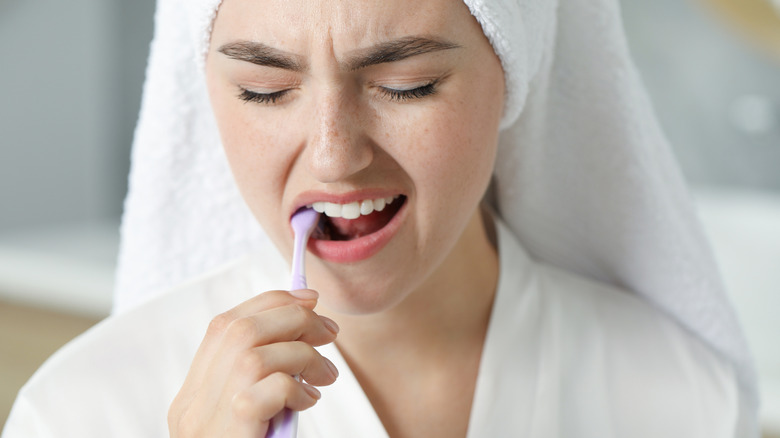 woman disliking the taste of her toothpaste