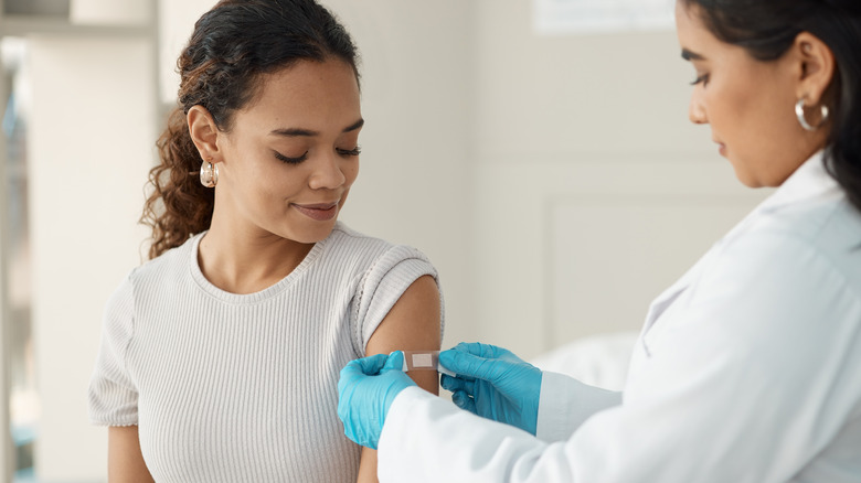 Doctor bandaging patient's arm